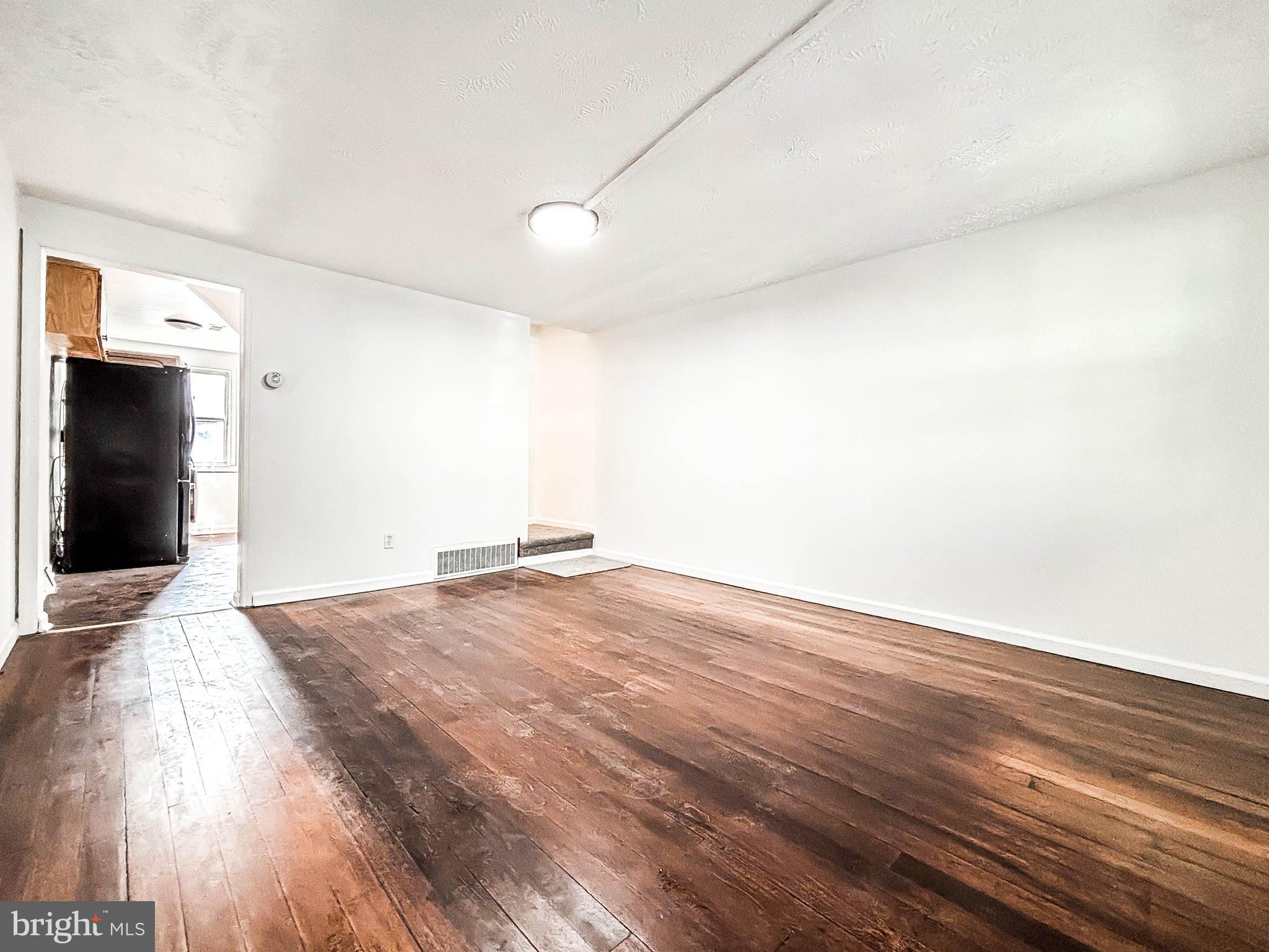 414 Avondale Road Dundalk, MD 21222 - Photo 7 of 33 a view of empty room with wooden floor and fan
