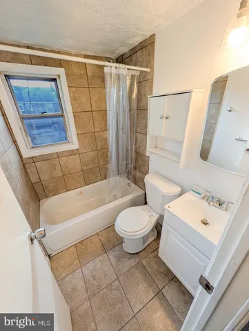 a bathroom with a toilet a sink and bathtub