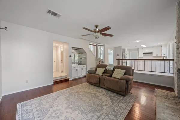a living room with furniture and a view of kitchen