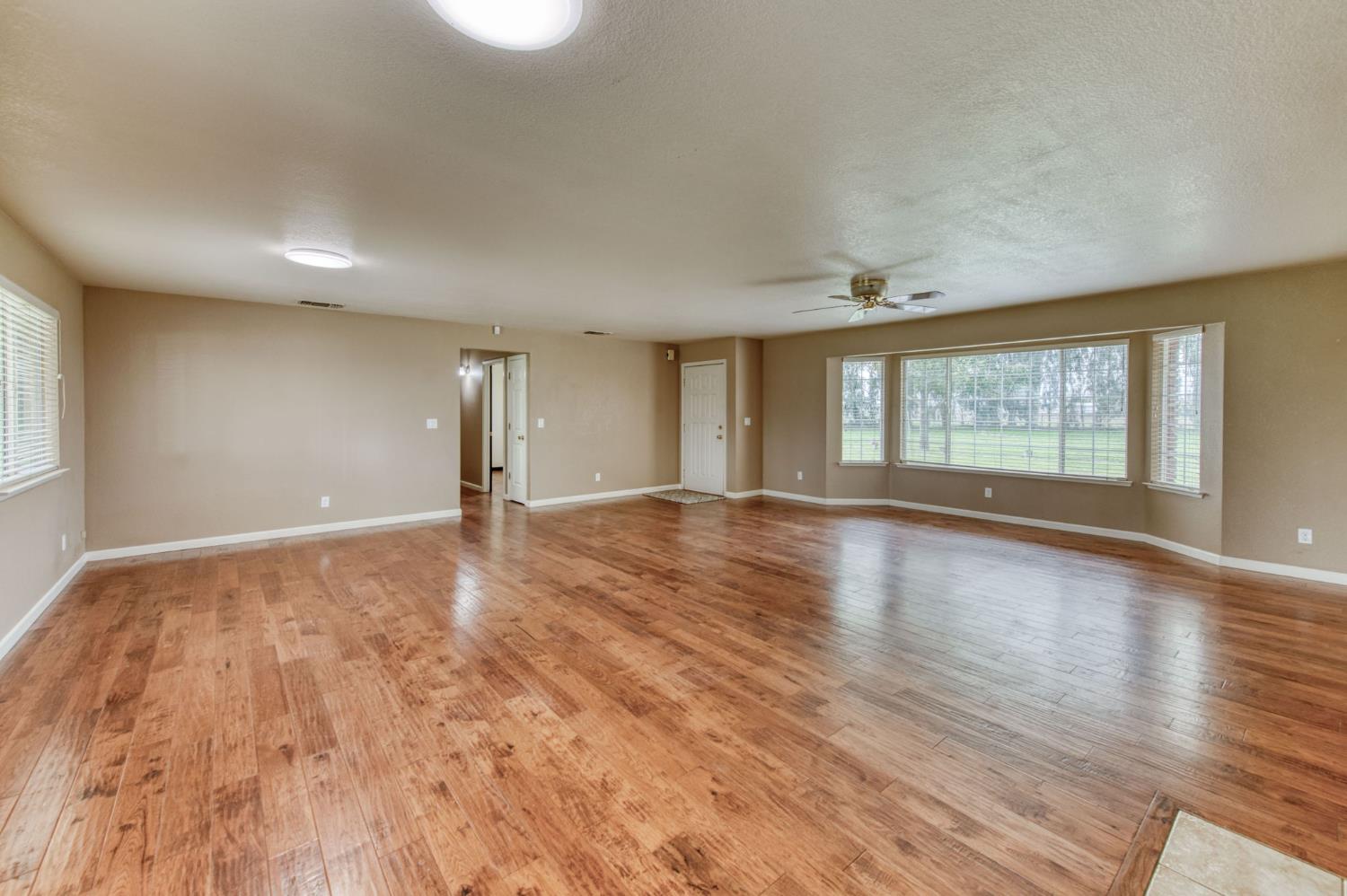 16036 South Del Rey Avenue Kingsburg, CA 93631 - Photo 21 of 64 an empty room with wooden floor and windows
