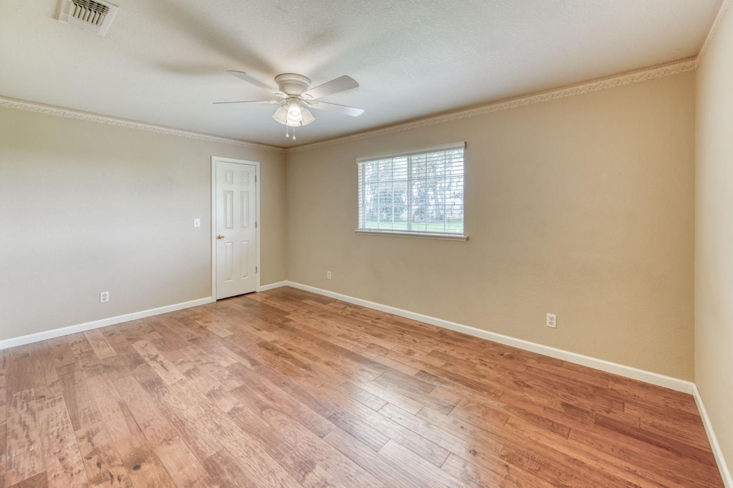 16036 South Del Rey Avenue Kingsburg, CA 93631 - Photo 30 of 64 a view of an empty room with wooden floor and a window
