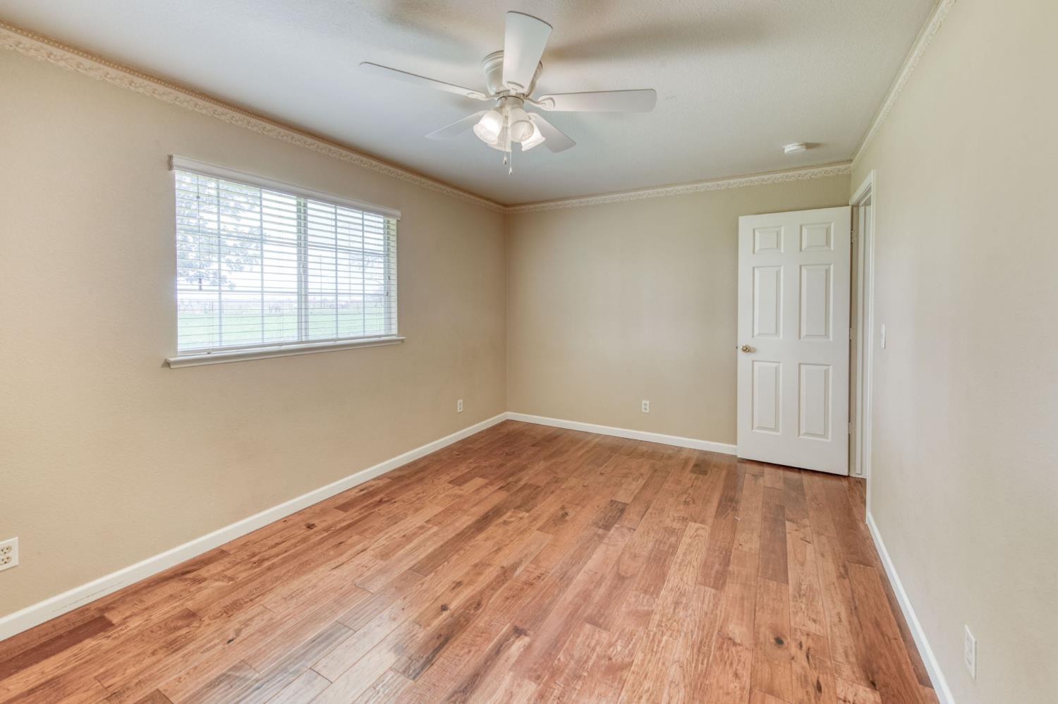 16036 South Del Rey Avenue Kingsburg, CA 93631 - Photo 31 of 64 an empty room with wooden floor and windows