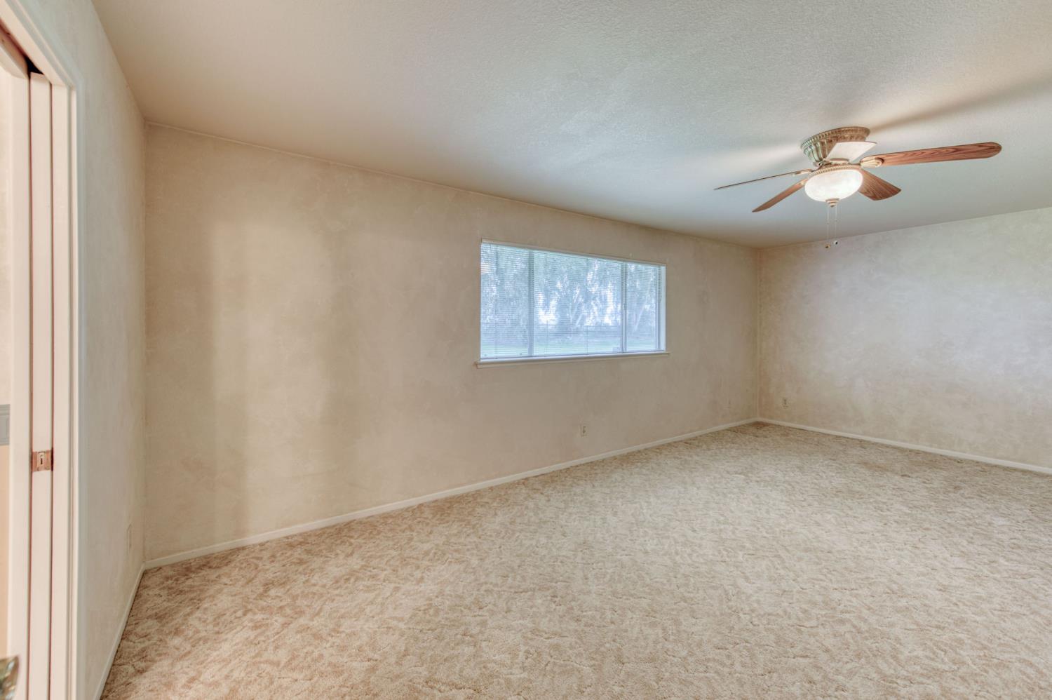 16036 South Del Rey Avenue Kingsburg, CA 93631 - Photo 32 of 64 an empty room with windows and fan