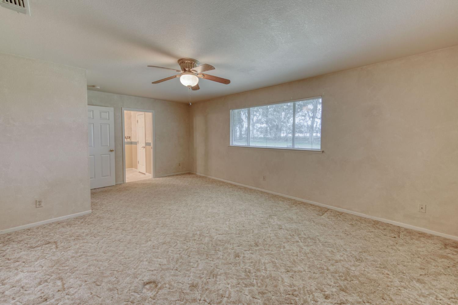 16036 South Del Rey Avenue Kingsburg, CA 93631 - Photo 34 of 64 an empty room with windows and ceiling fan view