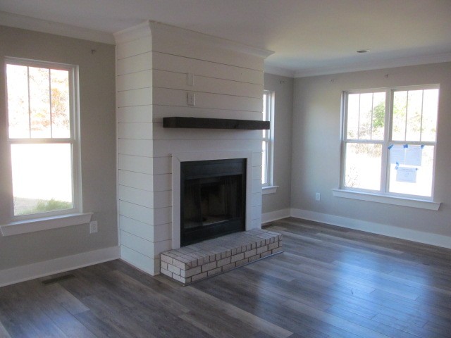 1158 Neal Road Watertown, TN 37184 - Photo 4 of 15 an empty room with wooden floor fireplace and windows