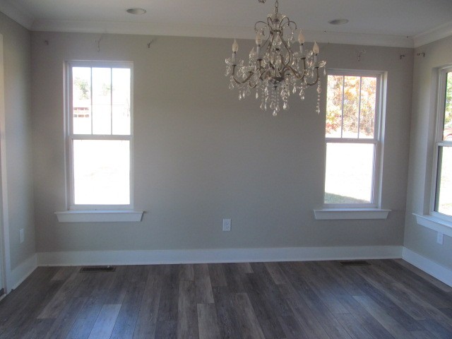 1158 Neal Road Watertown, TN 37184 - Photo 6 of 15 an empty room with wooden floor chandelier and windows