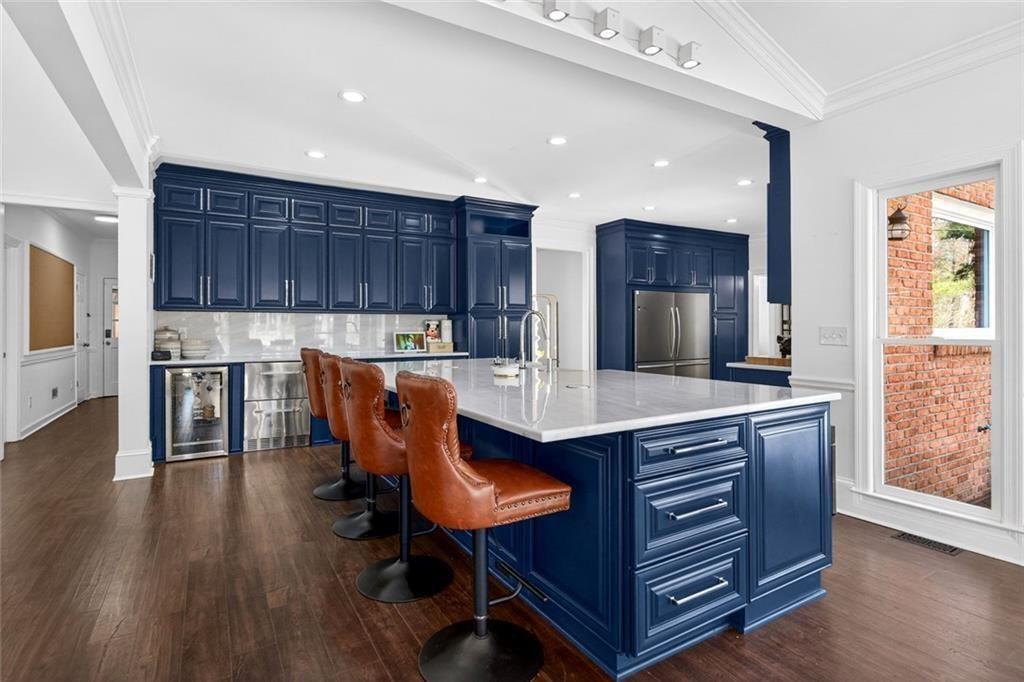 1026 Quaker Ridge Way Johns Creek, GA 30097 - Photo 14 of 80 a kitchen with granite countertop a table chairs stove and refrigerator