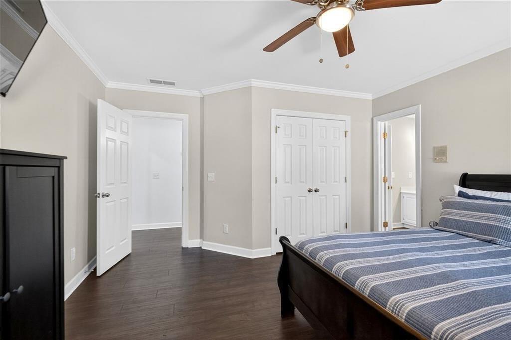 1026 Quaker Ridge Way Johns Creek, GA 30097 - Photo 42 of 80 a bedroom with a bed and a chandelier