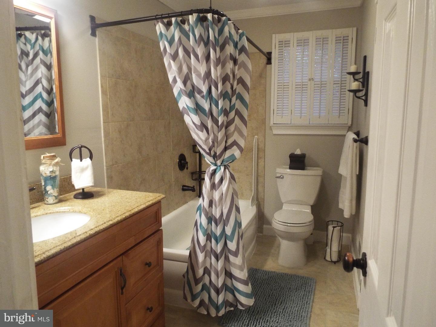 7 Ohio State Drive Riverside, NJ 08075 - Photo 14 of 25 a bathroom with a sink a toilet and shower curtain