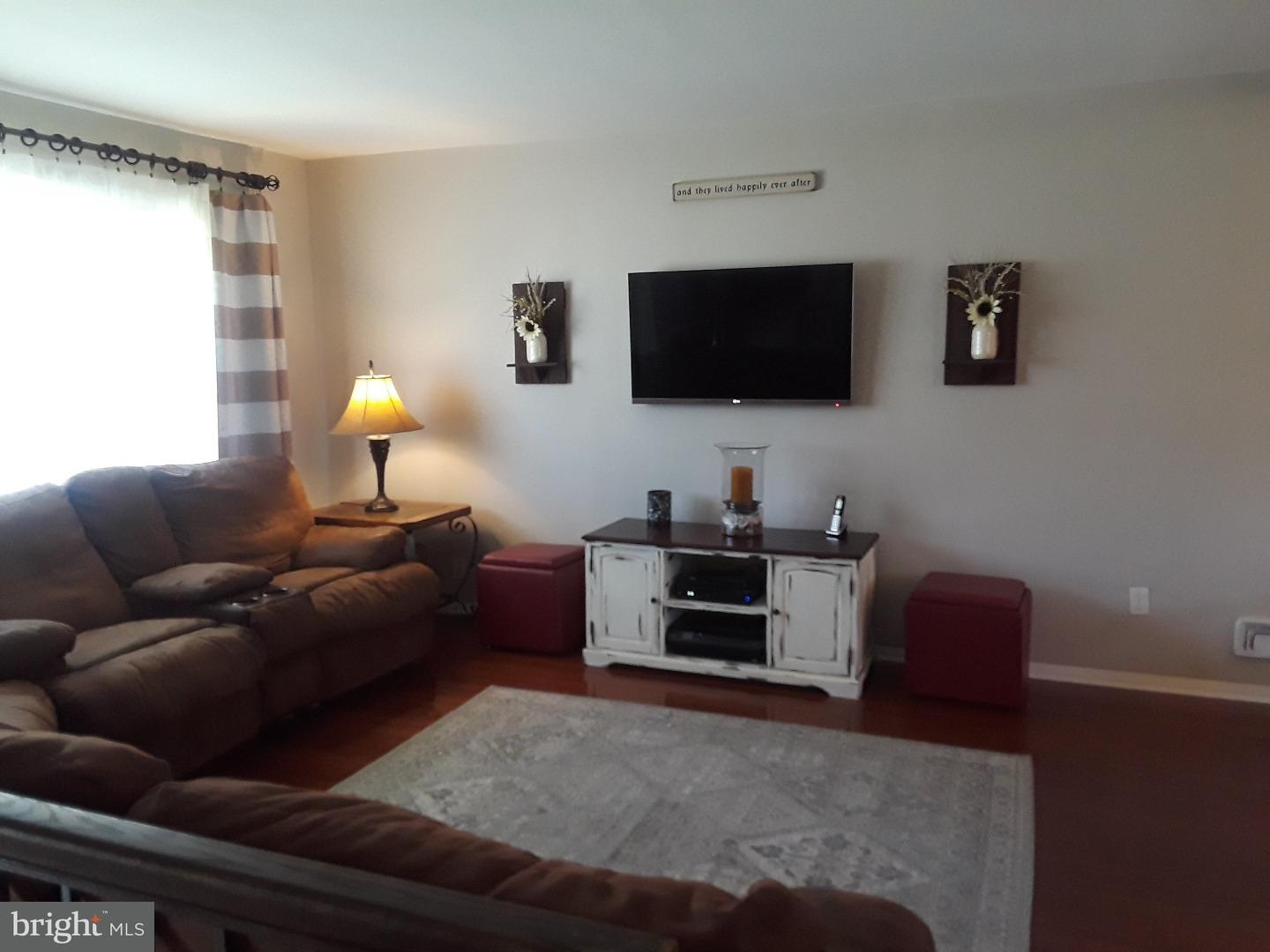7 Ohio State Drive Riverside, NJ 08075 - Photo 8 of 25 a living room with furniture and a flat screen tv