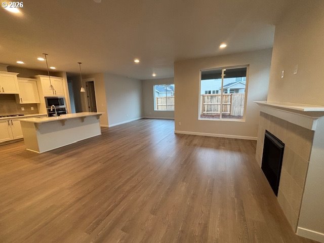 1585 Young Street Lafayette, OR 97127 - Photo 6 of 23 an empty room with wooden floor and fireplace