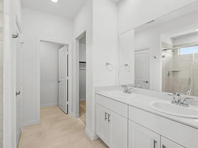 a bathroom with a shower sink and mirror