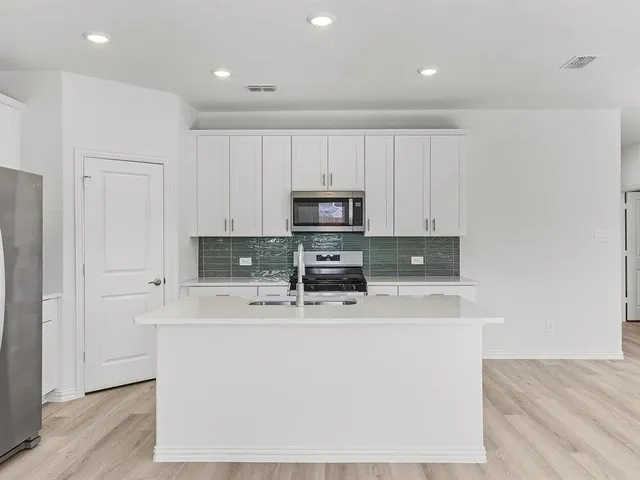 a view of a kitchen with a sink and a window