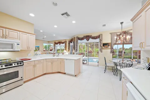 a kitchen with cabinets and chairs