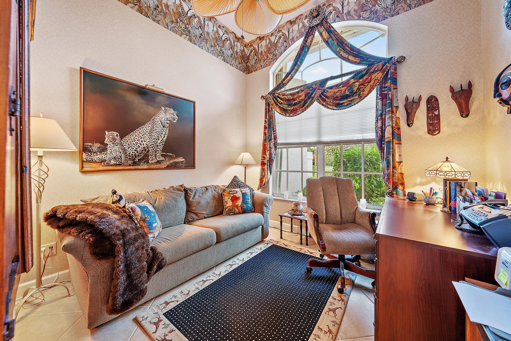 8157 Southeast Double Tree Drive Hobe Sound, FL 33455 - Photo 14 of 46 a living room with furniture and a floor to ceiling window