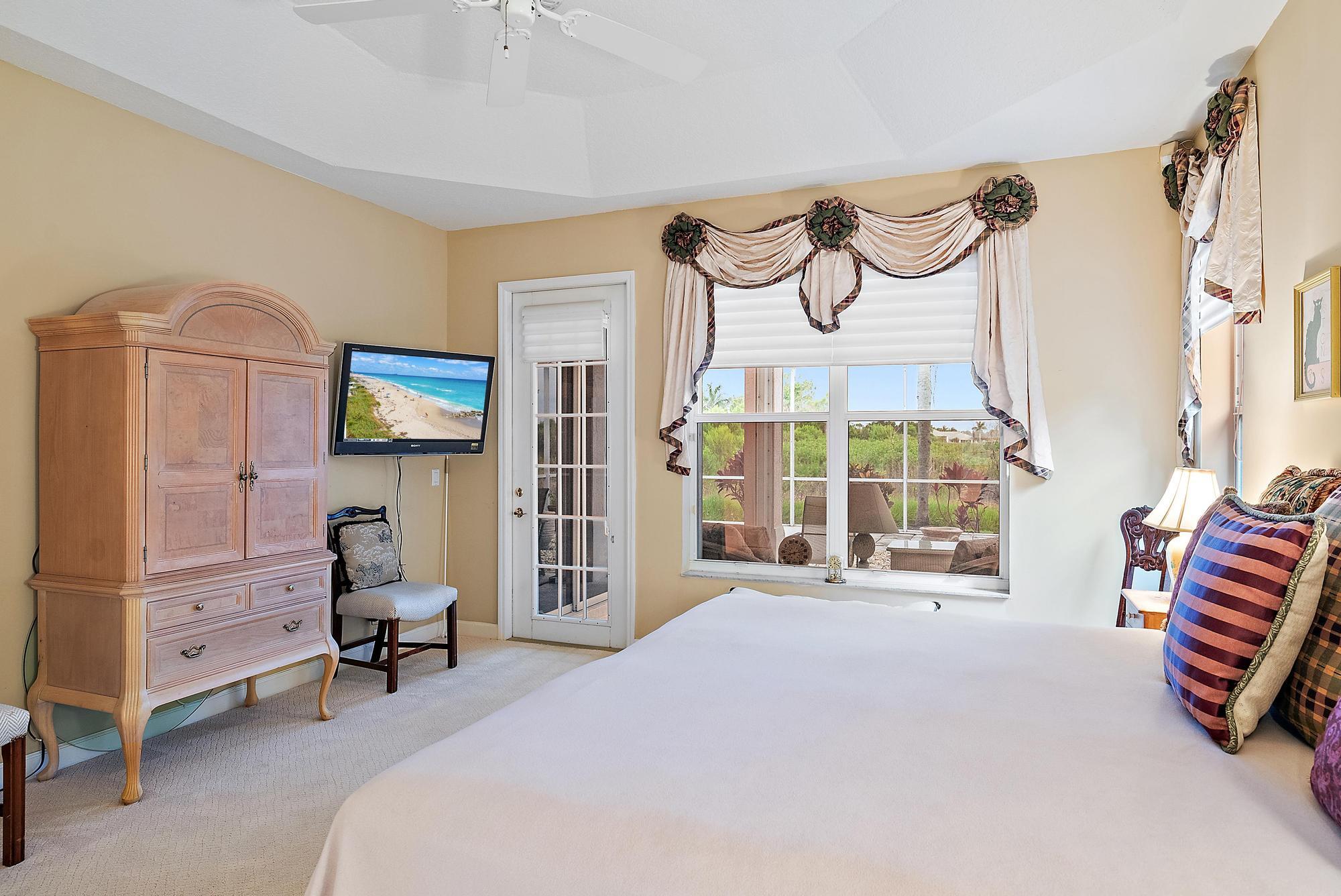 8157 Southeast Double Tree Drive Hobe Sound, FL 33455 - Photo 17 of 46 a bedroom with furniture and a window