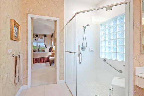 a bathroom with a tub shower and a sink