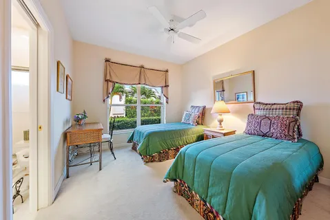 a bedroom with 2 bed and a chair