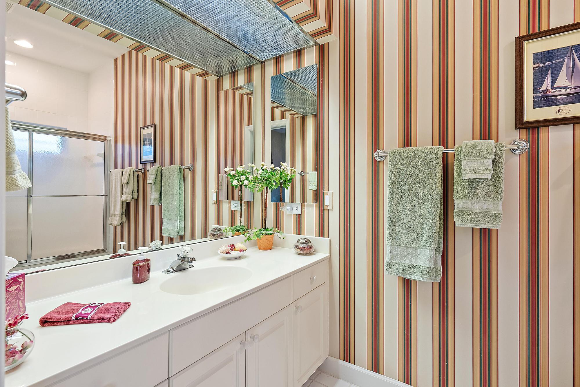 8157 Southeast Double Tree Drive Hobe Sound, FL 33455 - Photo 22 of 46 a bathroom with a sink and a mirror