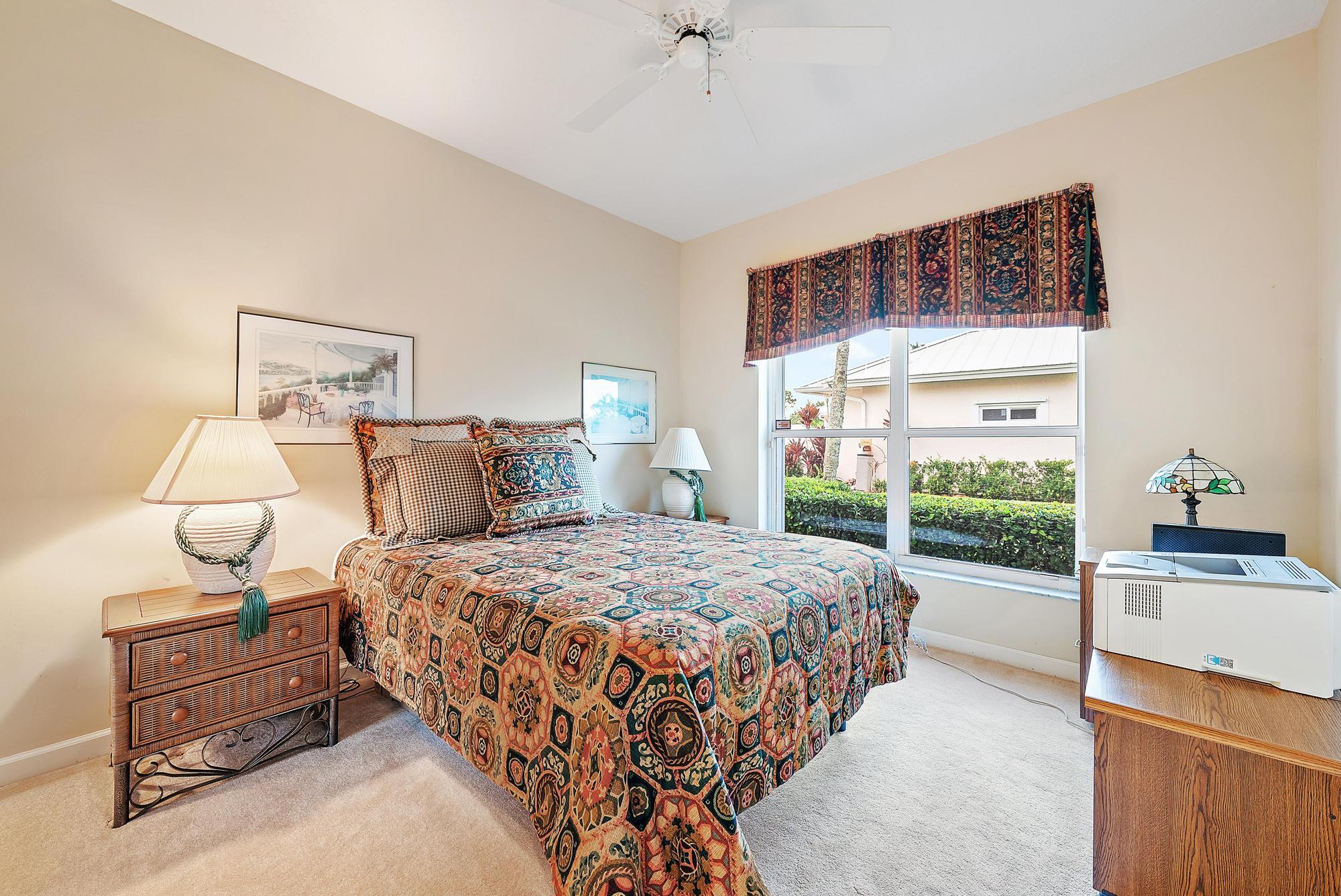 8157 Southeast Double Tree Drive Hobe Sound, FL 33455 - Photo 23 of 46 a bedroom with a bed and a night stand