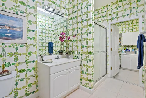 a bathroom with a sink a vanity and a shower curtain