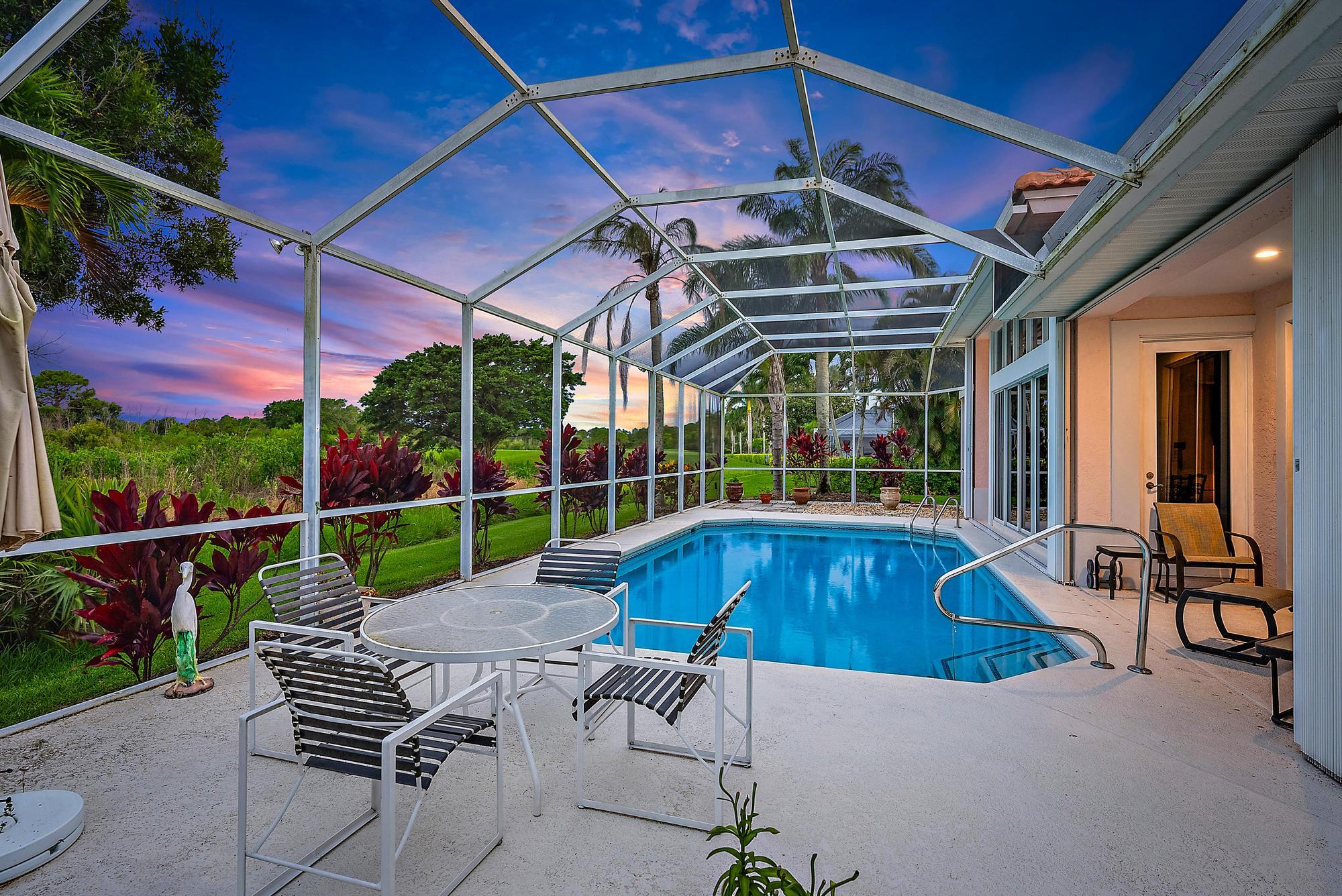 8157 Southeast Double Tree Drive Hobe Sound, FL 33455 - Photo 26 of 46 a patio with swimming pool table and chairs