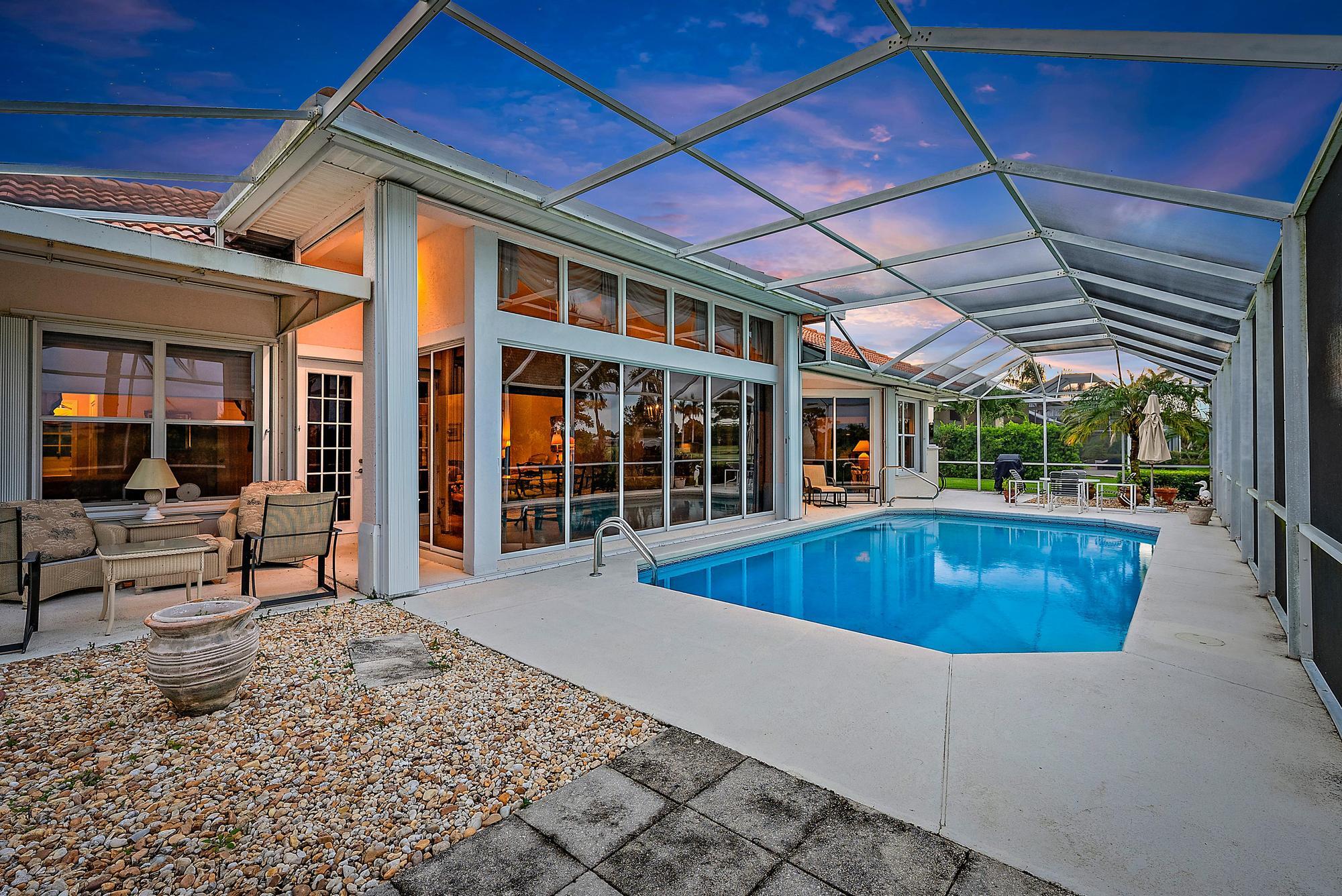 8157 Southeast Double Tree Drive Hobe Sound, FL 33455 - Photo 28 of 46 a view of a house with a swimming pool and sitting area