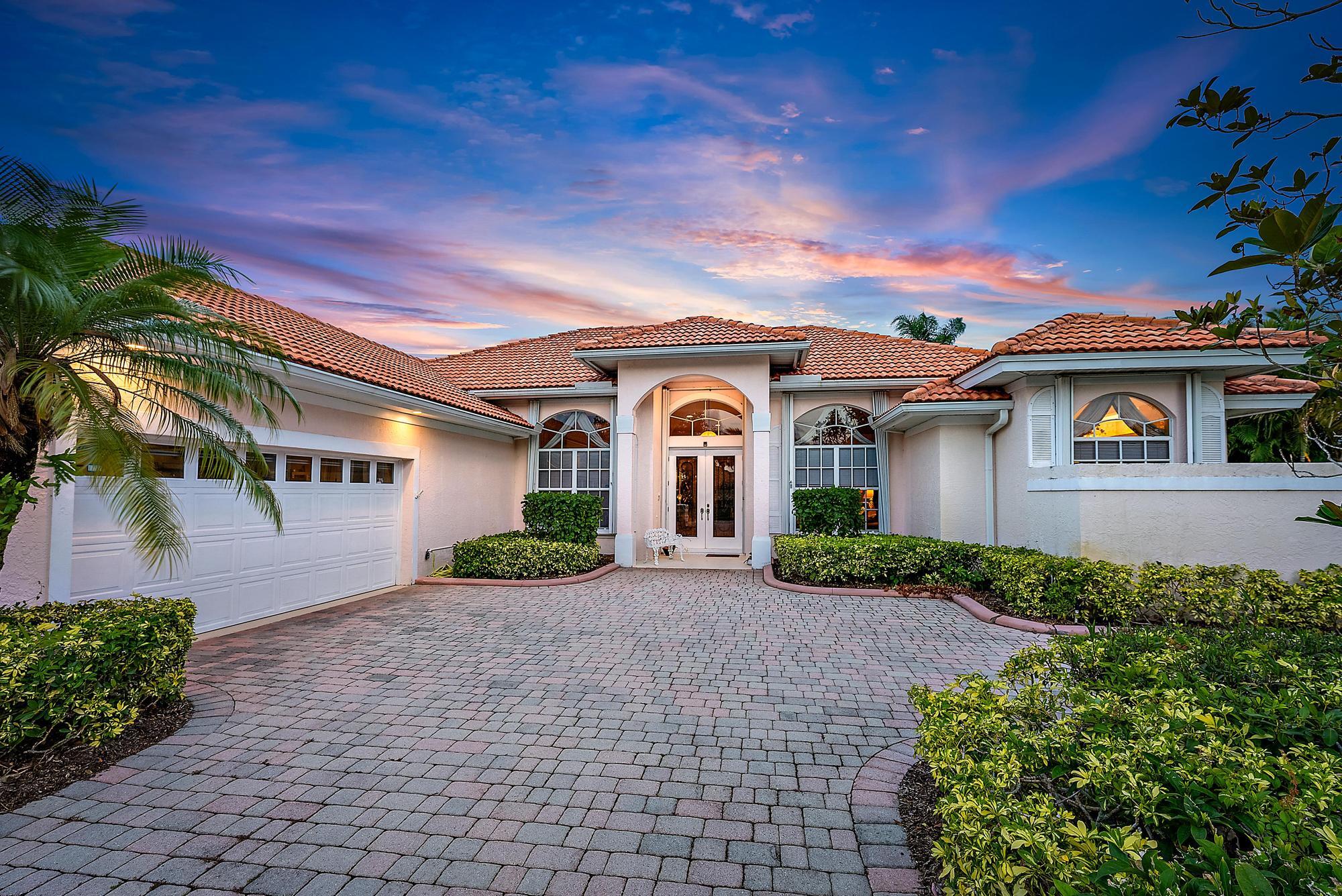 8157 Southeast Double Tree Drive Hobe Sound, FL 33455 - Photo 3 of 46 a front view of a house with garden