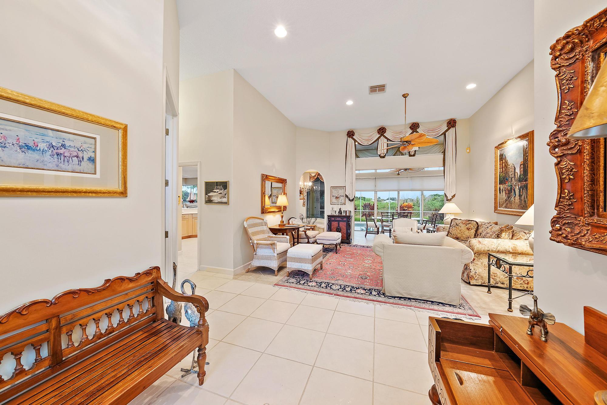 8157 Southeast Double Tree Drive Hobe Sound, FL 33455 - Photo 4 of 46 a living room with furniture and a flat screen tv