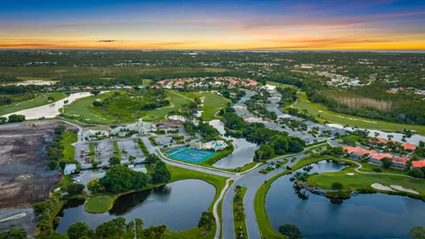 an aerial view of lake and residential houses with outdoor space
