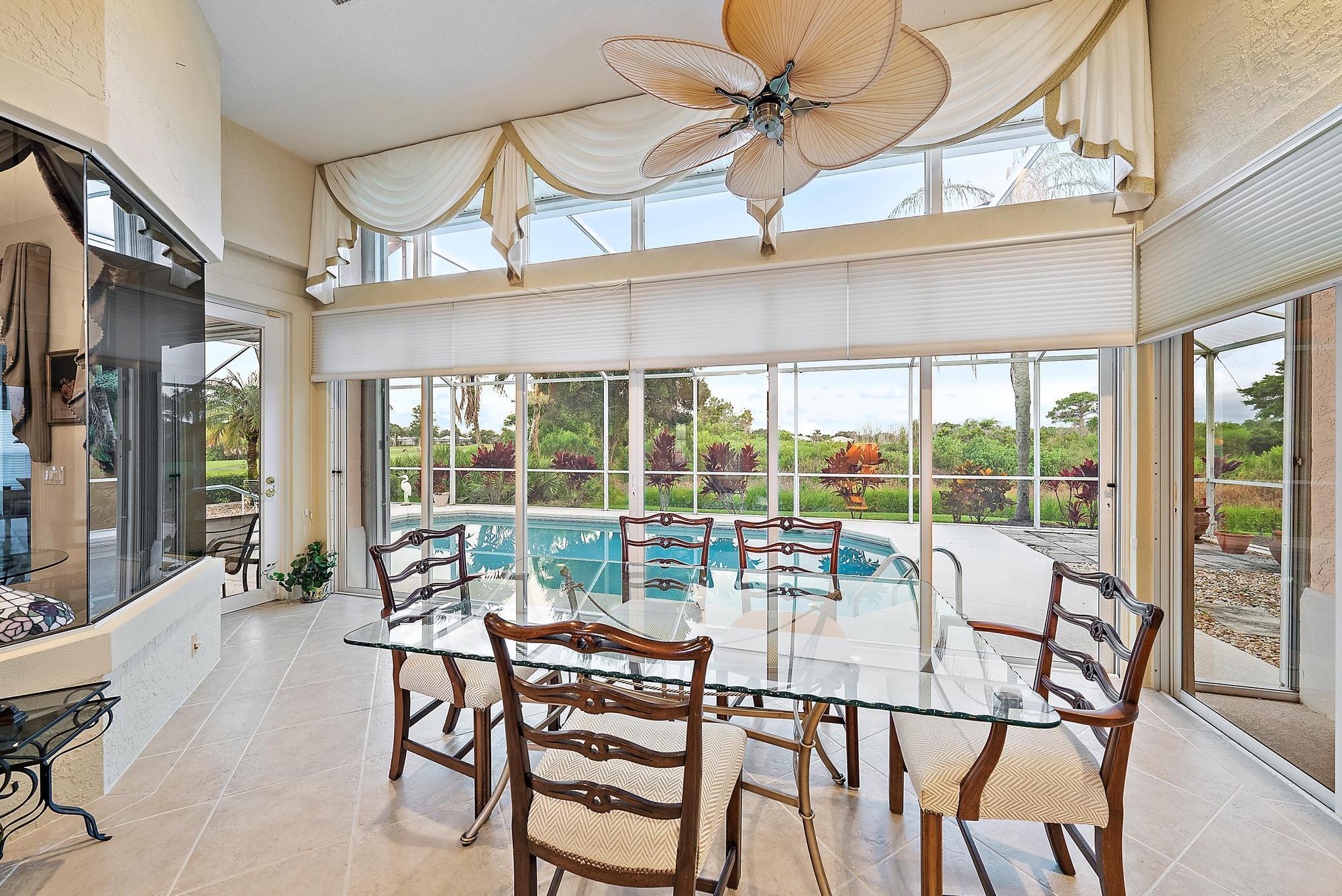 8157 Southeast Double Tree Drive Hobe Sound, FL 33455 - Photo 7 of 46 a living room with furniture and a large window