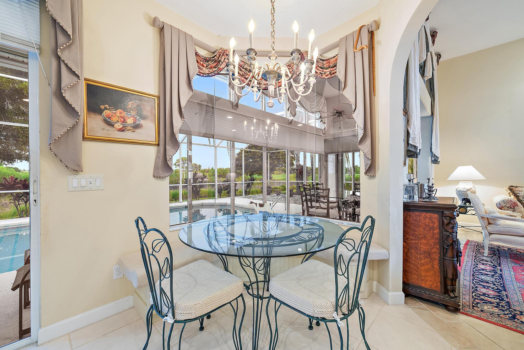 8157 Southeast Double Tree Drive Hobe Sound, FL 33455 - Photo 10 of 46 a view of a dining room with furniture wooden floor and a chandelier
