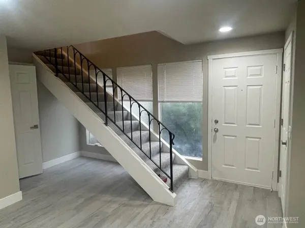 a view of an entryway with wooden floor