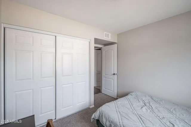 a bedroom with a bed and a shower