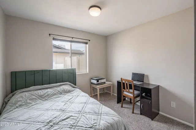 a bedroom with a bed and a desk