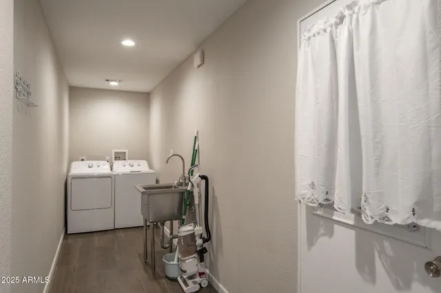 a room with a sink and a washer dryer