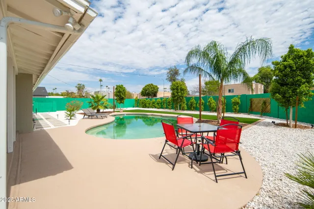 an outdoor sitting area with couch and umbrella