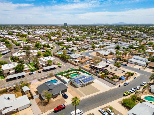 an aerial view of residential houses with outdoor space