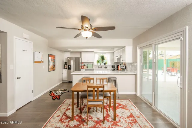 a view of a very nice looking dining room with a rug and a chandelier