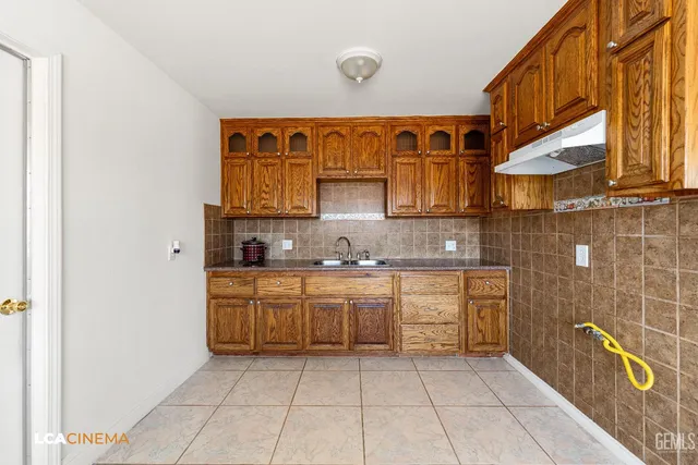 a kitchen with stainless steel appliances granite countertop a sink and cabinets