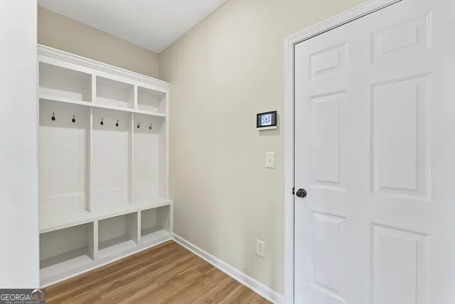 a view of an empty room with wooden floor