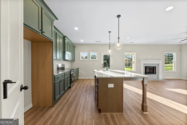 a kitchen with kitchen island a stove a sink and a refrigerator