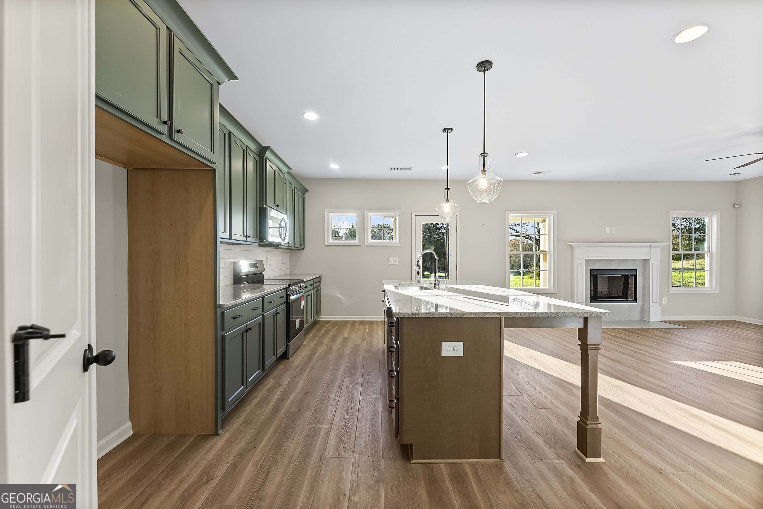 575 Mountain View Drive, Unit 17B Hamilton, GA 31811 - Photo 32 of 34 a kitchen with kitchen island a stove a sink and a refrigerator