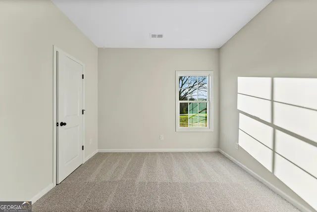 a view of room with window and hardwood floor