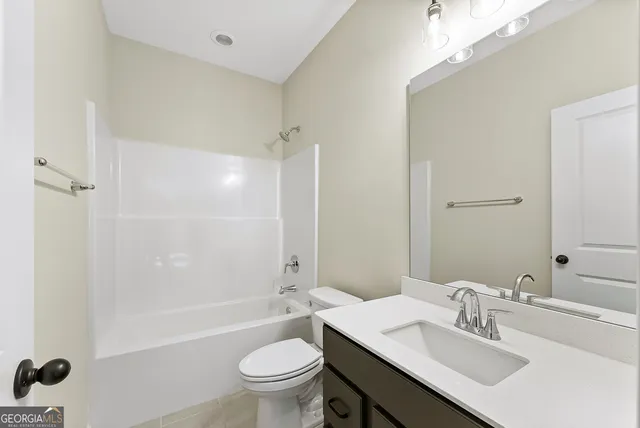 a bathroom with a sink toilet tub and shower