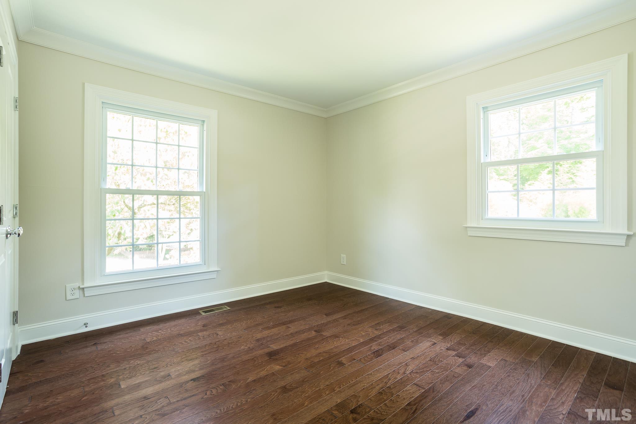 3101 Merrianne Drive Raleigh, NC 27607 - Photo 30 of 37 an empty room with wooden floor and windows