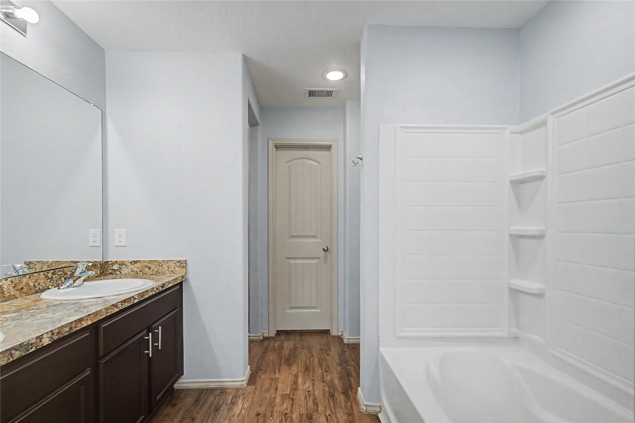 16430 Rodeo River Road Houston, TX 77049 - Photo 28 of 34 a bathroom with a granite countertop sink a toilet and shower