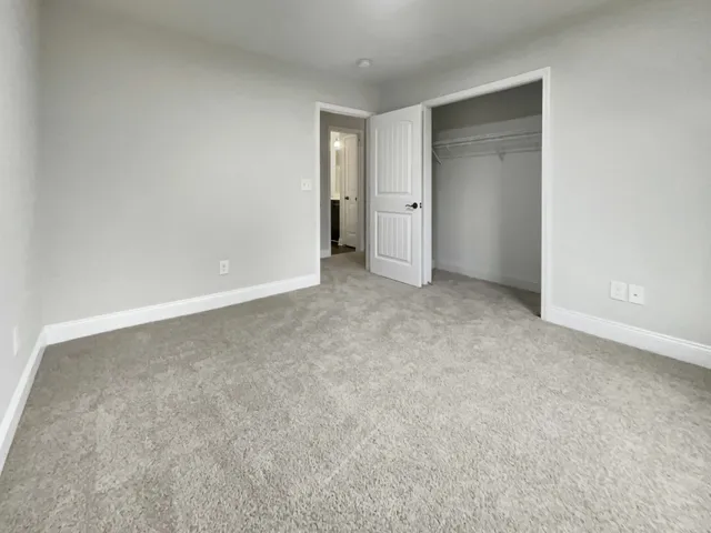 a view of an empty room and closet area