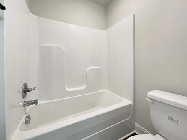 a bathroom with a bathtub and toilet