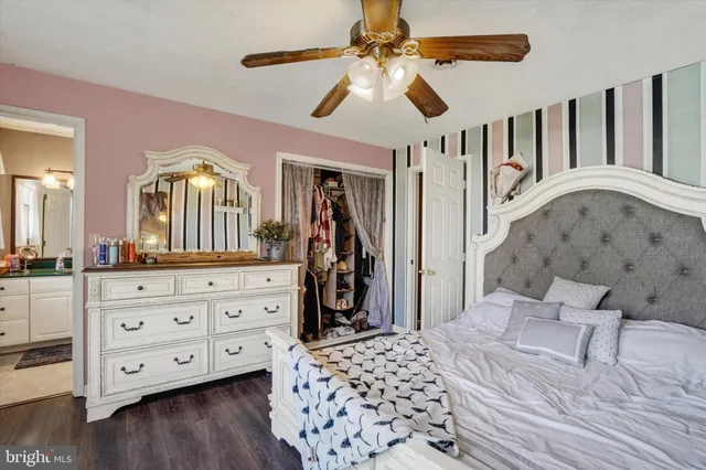 a bedroom with a large bed and a chandelier